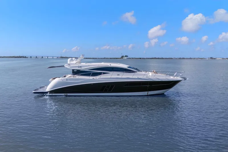 The Image of 2017 Sea Ray L590 yacht cruising on calm waters under a clear blue sky. - 0