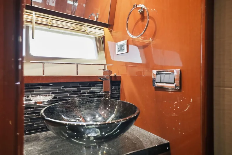 Slide: The Image of Luxurious bathroom interior of 2017 Sea Ray L590 yacht with elegant glass sink. - 102