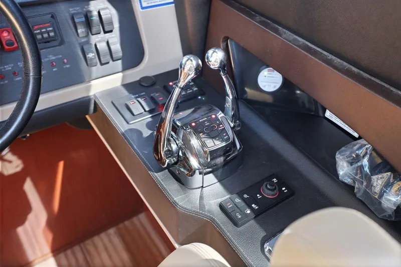 Slide: The Image of Control panel of a 2017 Sea Ray L590 yacht, featuring dual throttle levers and navigation controls. - 108