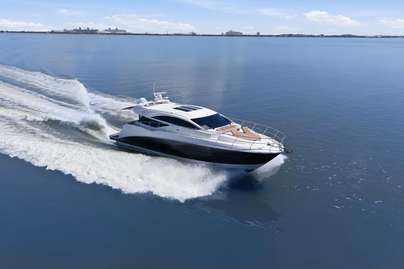 Slide: The Image of 2017 Sea Ray L590 yacht cruising on calm blue waters. - 11