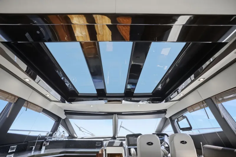 Slide: The Image of Interior view of 2017 Sea Ray L590 yacht with panoramic sunroof and luxurious seating. - 110