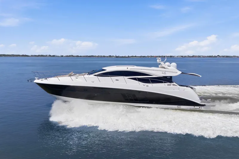 Slide: The Image of 2017 Sea Ray L590 yacht cruising on open water under a clear blue sky. - 12
