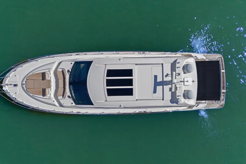 Slide: The Image of Aerial view of 2017 Sea Ray L590 yacht cruising on clear green water. - 14