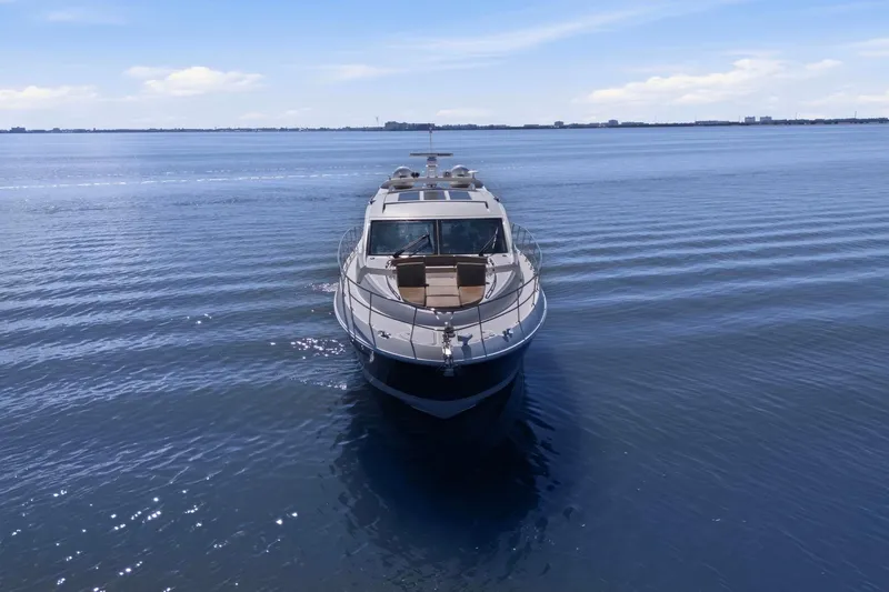 Slide: The Image of 2017 Sea Ray L590 yacht cruising on calm blue waters under a clear sky. - 17