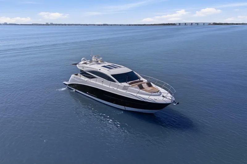 Slide: The Image of 2017 Sea Ray L590 yacht cruising on calm blue waters under a clear sky. - 18