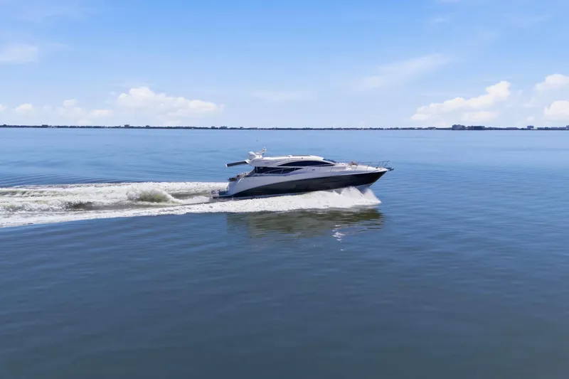 Slide: The Image of 2017 Sea Ray L590 yacht cruising on calm blue waters under a clear sky. - 2