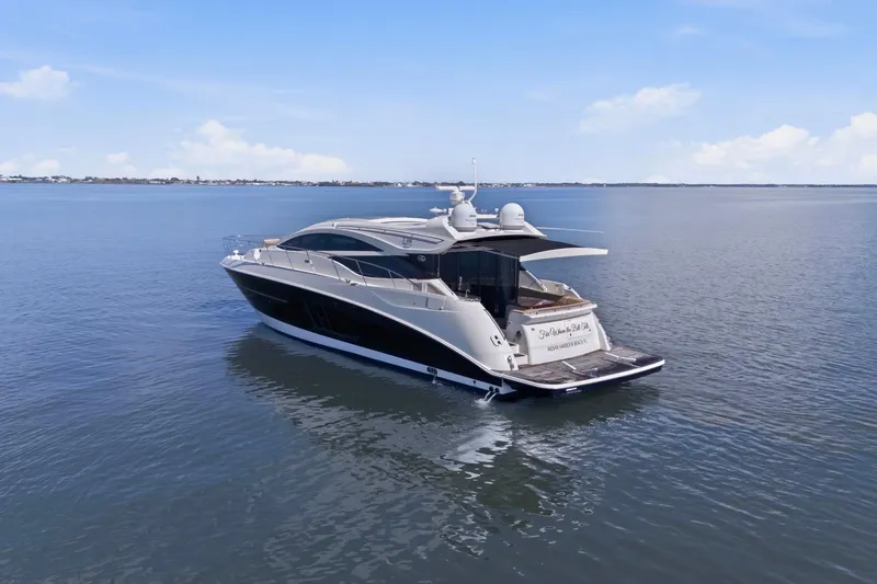 Slide: The Image of 2017 Sea Ray L590 yacht cruising on calm waters under a clear blue sky. - 21