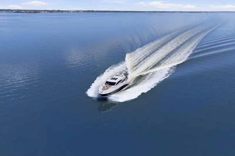 Slide: The Image of 2017 Sea Ray L590 yacht cruising on calm blue waters, leaving a wake behind. - 3