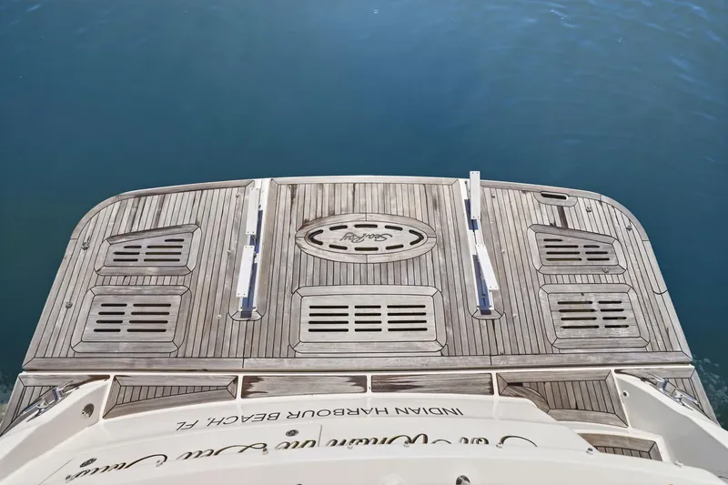 Slide: The Image of 2017 Sea Ray L590 yacht swim platform with teak decking on calm water. - 30