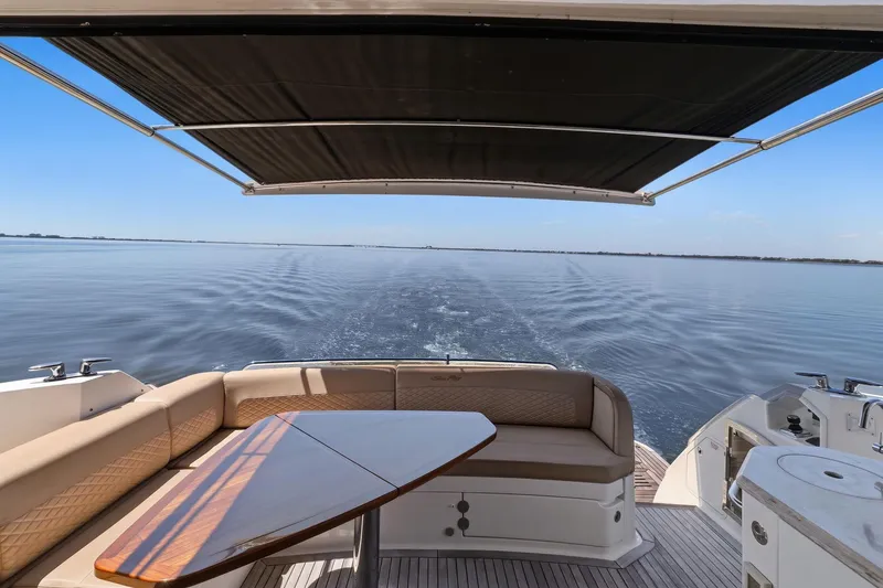 Slide: The Image of 2017 Sea Ray L590 yacht with shaded deck, cruising on calm waters. - 32