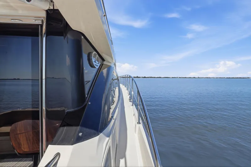 Slide: The Image of 2017 Sea Ray L590 yacht cruising on calm blue waters under a clear sky. - 36