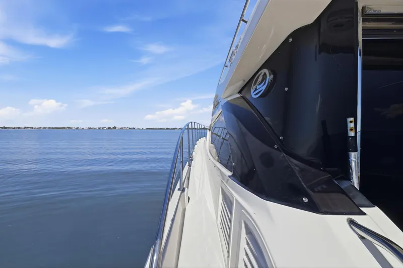 Slide: The Image of 2017 Sea Ray L590 yacht cruising on calm blue waters under a clear sky. - 37