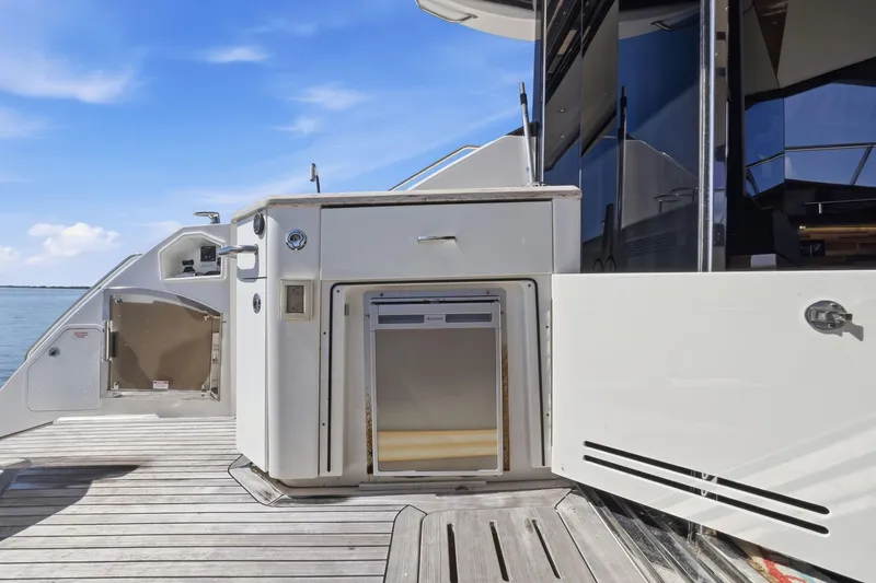 Slide: The Image of 2017 Sea Ray L590 yacht deck with outdoor kitchen and ocean view. - 38