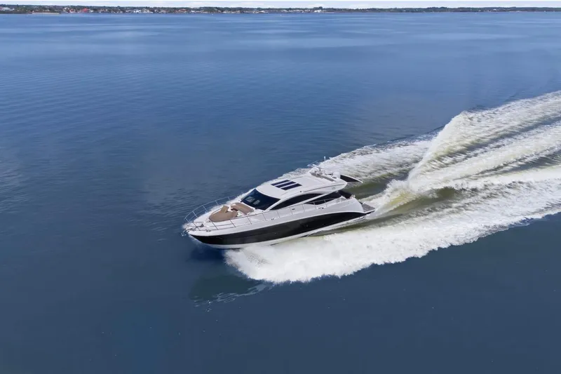 Slide: The Image of 2017 Sea Ray L590 yacht cruising on calm blue waters. - 4