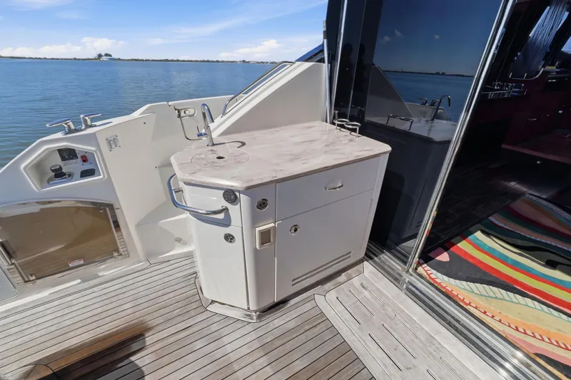 Slide: The Image of Outdoor kitchenette on 2017 Sea Ray L590 yacht with ocean view. - 40