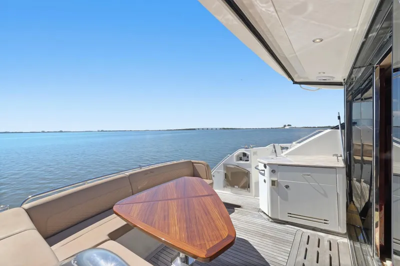 Slide: The Image of Luxurious 2017 Sea Ray L590 yacht deck with seating and ocean view. - 41
