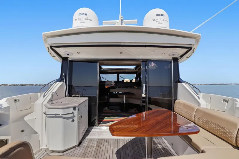 Slide: The Image of Luxurious 2017 Sea Ray L590 yacht with elegant outdoor seating and dining area. - 44