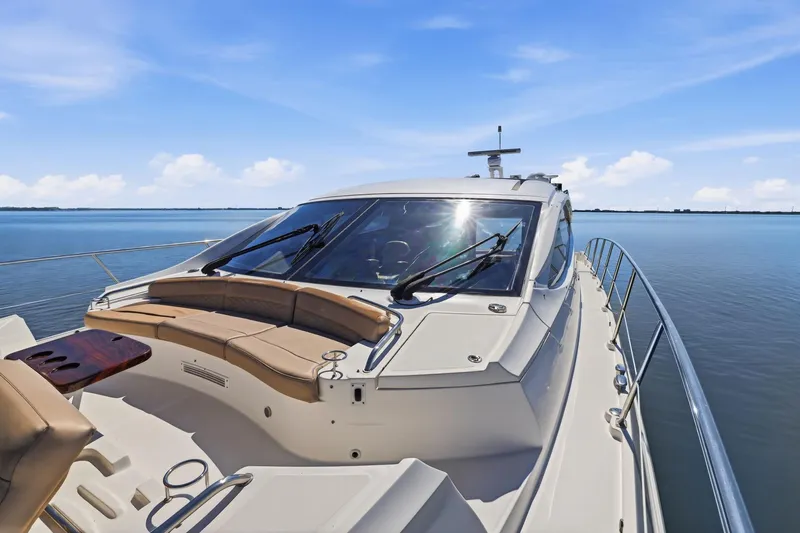 Slide: The Image of 2017 Sea Ray L590 yacht on calm water, featuring sleek design and luxurious seating. - 46