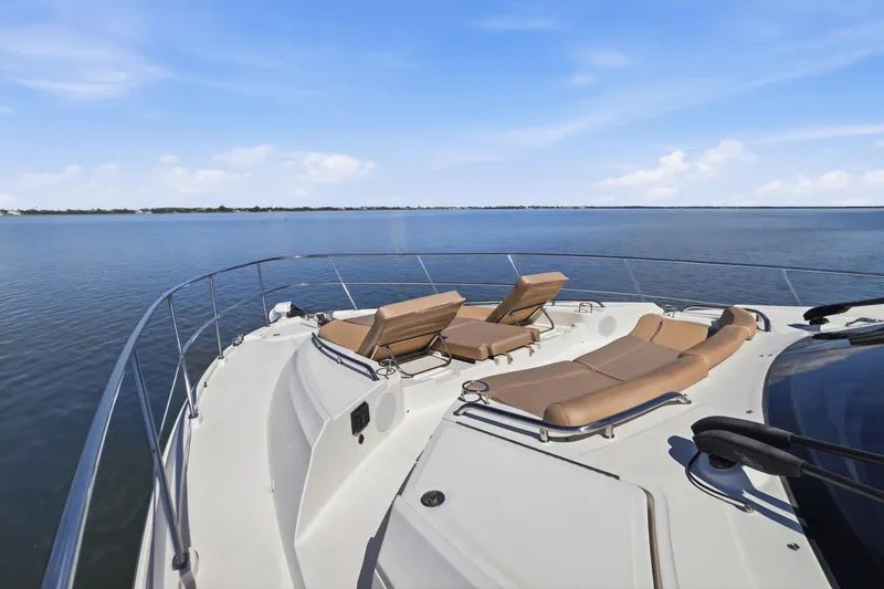 Slide: The Image of Luxurious 2017 Sea Ray L590 yacht with sun loungers on a serene water backdrop. - 48