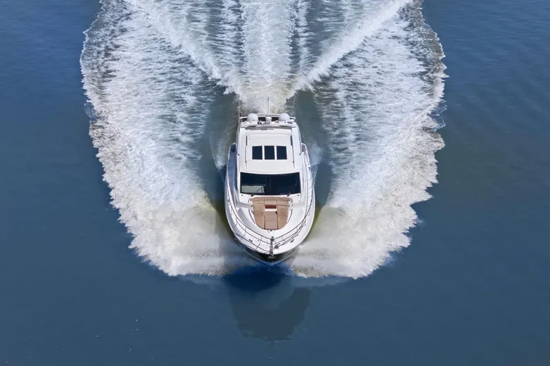 Slide: The Image of 2017 Sea Ray L590 yacht cruising on open water, creating a dynamic wake. - 5