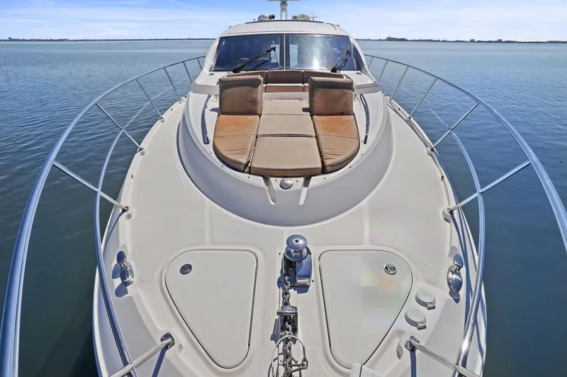 Slide: The Image of 2017 Sea Ray L590 yacht with spacious deck and luxurious seating on calm waters. - 52