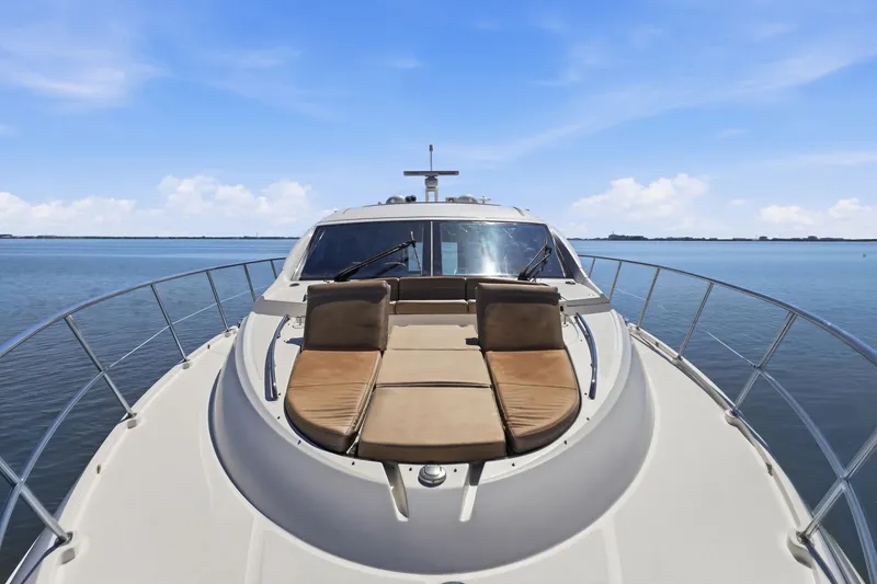 Slide: The Image of 2017 Sea Ray L590 yacht with sun loungers on deck, cruising on calm waters. - 53