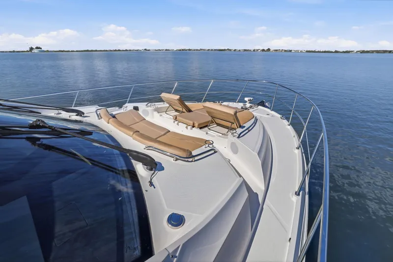 Slide: The Image of Luxurious 2017 Sea Ray L590 yacht with sun loungers on calm water. - 54
