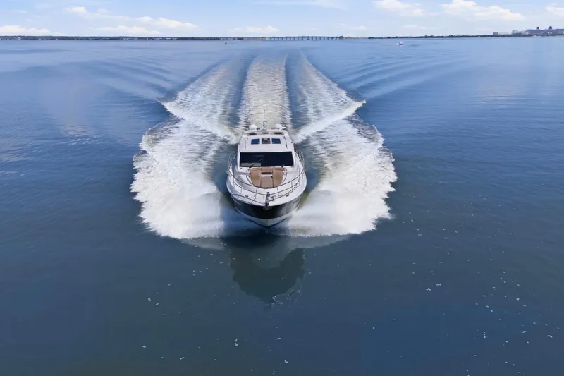Slide: The Image of 2017 Sea Ray L590 yacht cruising on calm blue waters. - 6