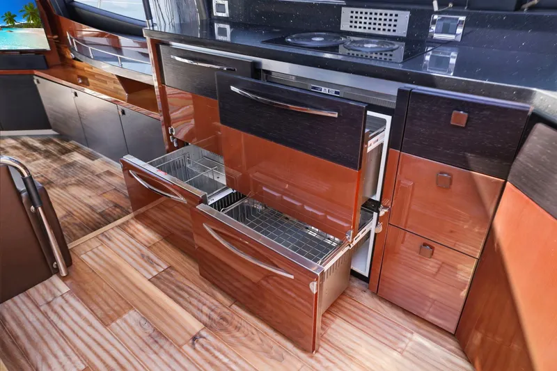 Slide: The Image of Luxurious 2017 Sea Ray L590 yacht kitchen with sleek cabinetry and modern appliances. - 63