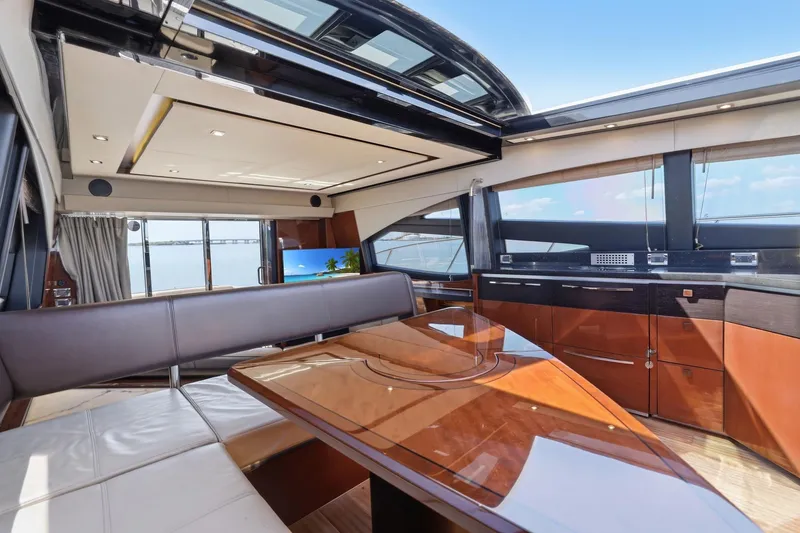 Slide: The Image of Luxurious interior of 2017 Sea Ray L590 yacht with elegant wood finishes and panoramic windows. - 66