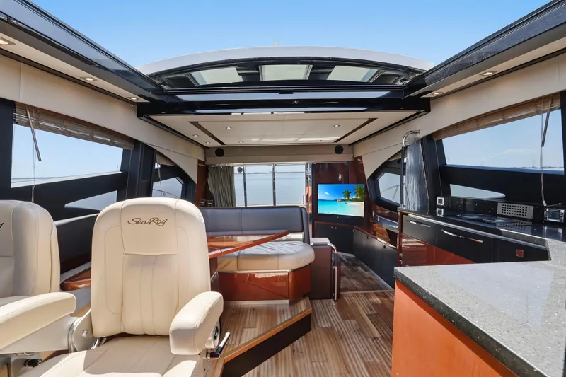 Slide: The Image of Luxurious interior of 2017 Sea Ray L590 yacht with elegant seating and panoramic windows. - 67