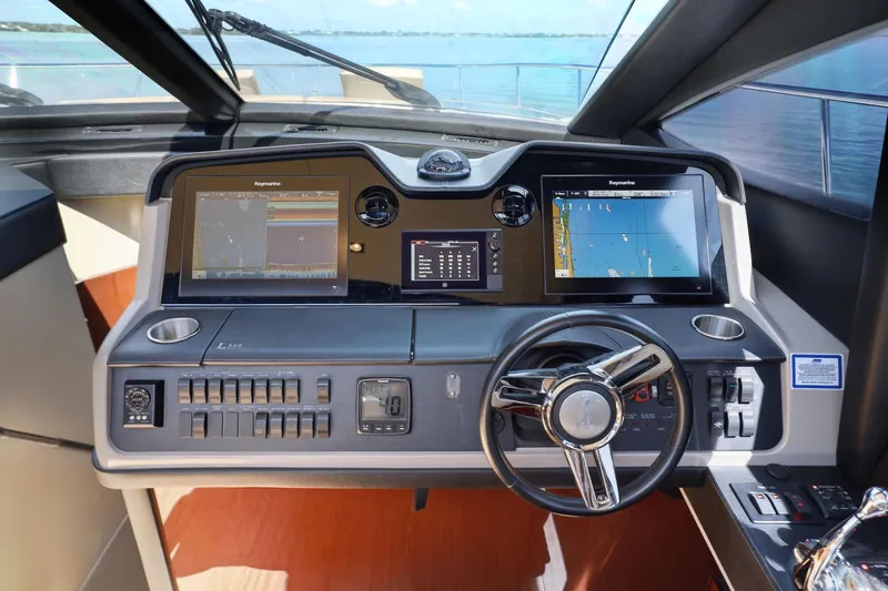 Slide: The Image of 2017 Sea Ray L590 helm with advanced navigation displays and controls. - 70