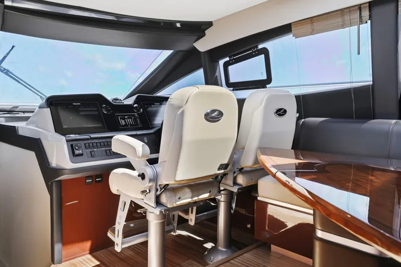 Slide: The Image of 2017 Sea Ray L590 yacht cockpit with modern controls and luxurious seating. - 72