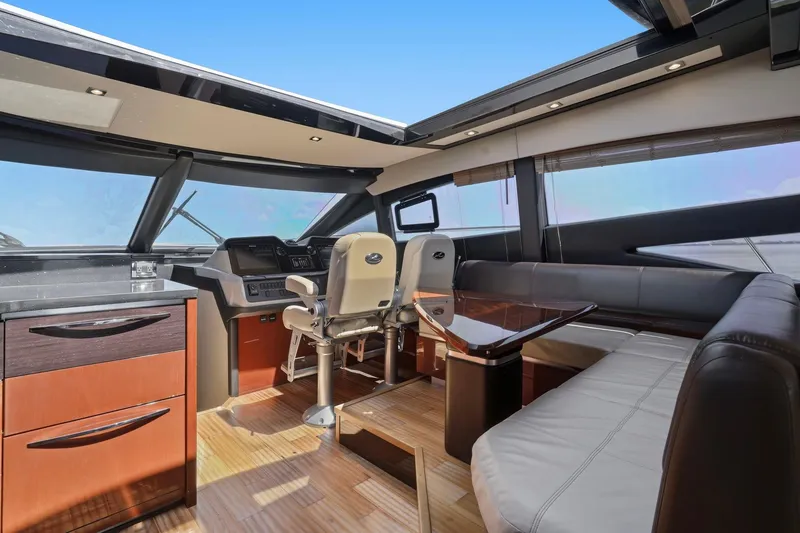 Slide: The Image of Luxurious interior of 2017 Sea Ray L590 yacht with modern seating and navigation area. - 73
