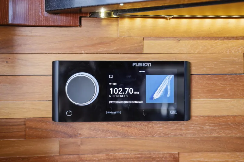 Slide: The Image of Fusion stereo system on 2017 Sea Ray L590 yacht, displaying 102.70 MHz frequency. - 76