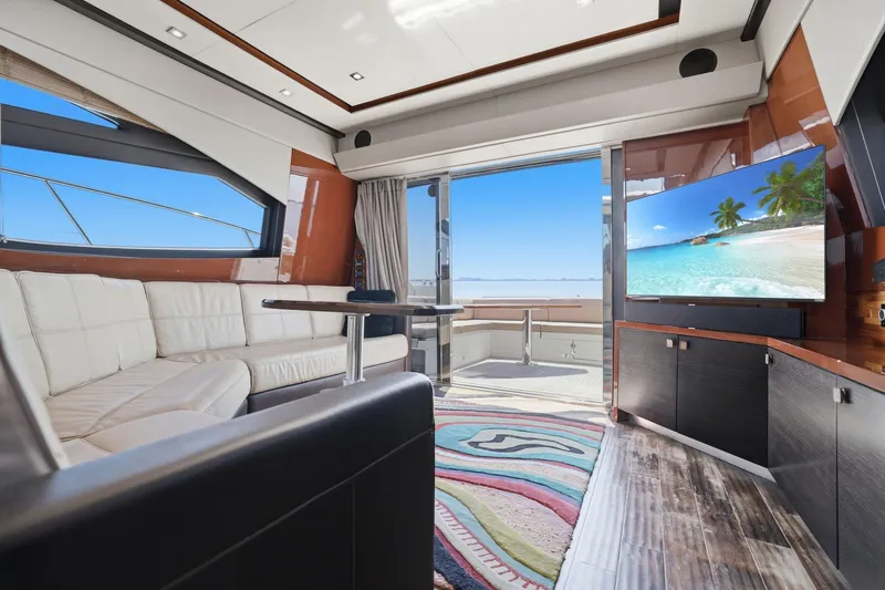 Slide: The Image of Luxurious 2017 Sea Ray L590 yacht interior with plush seating and ocean view. - 79
