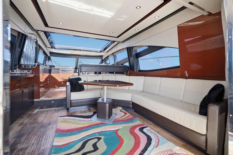 Slide: The Image of Luxurious 2017 Sea Ray L590 yacht interior with elegant seating and vibrant rug. - 81