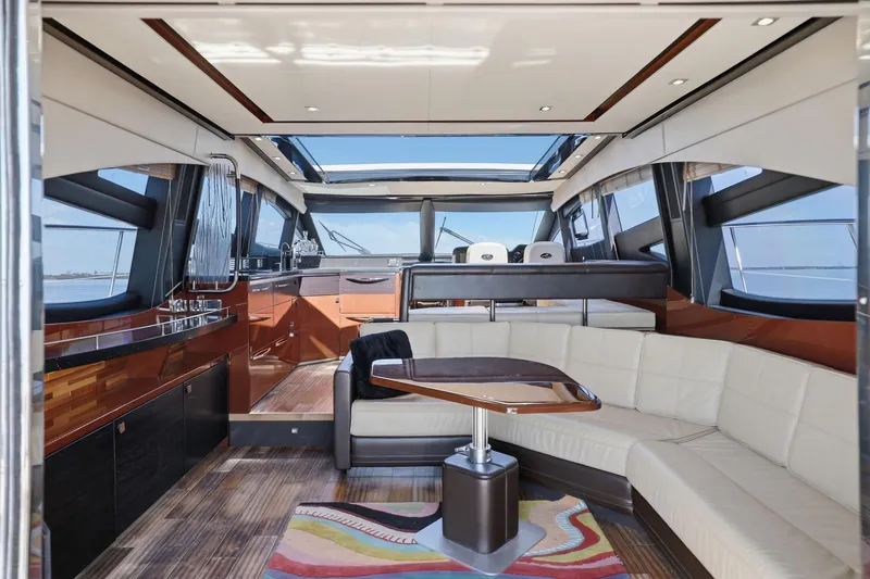 Slide: The Image of Luxurious interior of 2017 Sea Ray L590 yacht with modern seating and panoramic windows. - 83