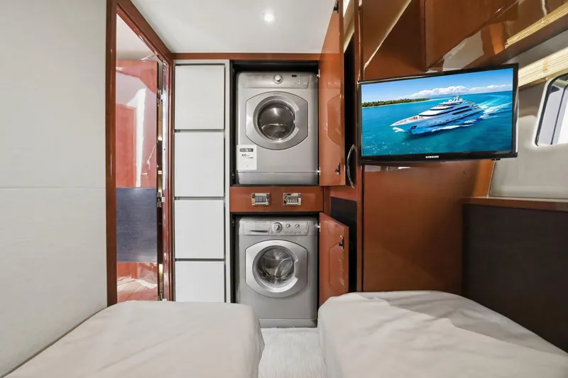 Slide: The Image of 2017 Sea Ray L590 yacht interior with washer, dryer, and TV in cabin. - 85