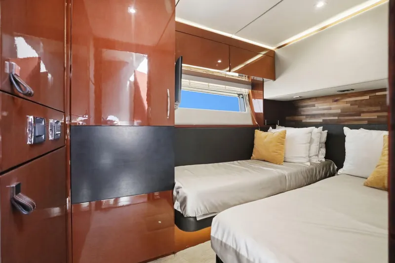 Slide: The Image of Luxurious 2017 Sea Ray L590 yacht cabin with twin beds and elegant wood finishes. - 86