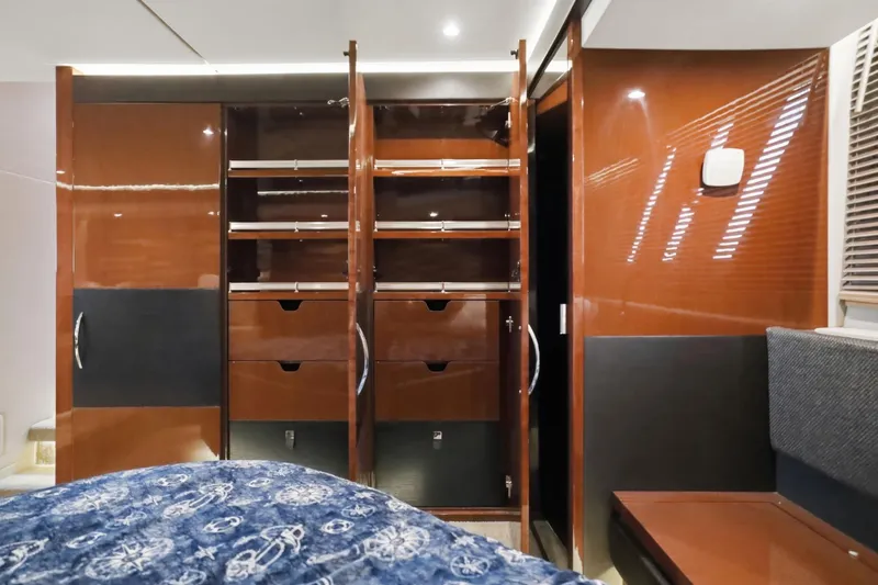Slide: The Image of Luxurious 2017 Sea Ray L590 yacht interior with open wooden cabinets and modern design. - 88