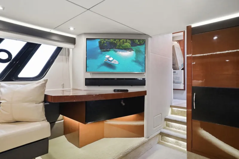 Slide: The Image of Luxurious interior of 2017 Sea Ray L590 yacht with modern decor and large TV screen. - 89
