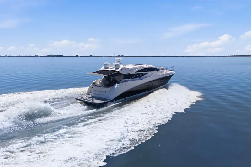 Slide: The Image of 2017 Sea Ray L590 yacht cruising on calm waters under a clear blue sky. - 9