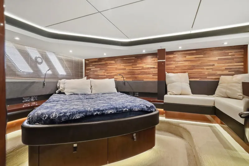 Slide: The Image of Luxurious 2017 Sea Ray L590 yacht interior with elegant wood paneling and plush bedding. - 92