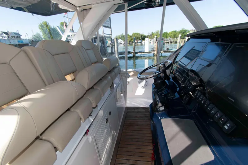 Slide: The Image of Interior view of 2019 Pursuit S 408 Sport boat with luxurious seating and advanced control panel. - 12