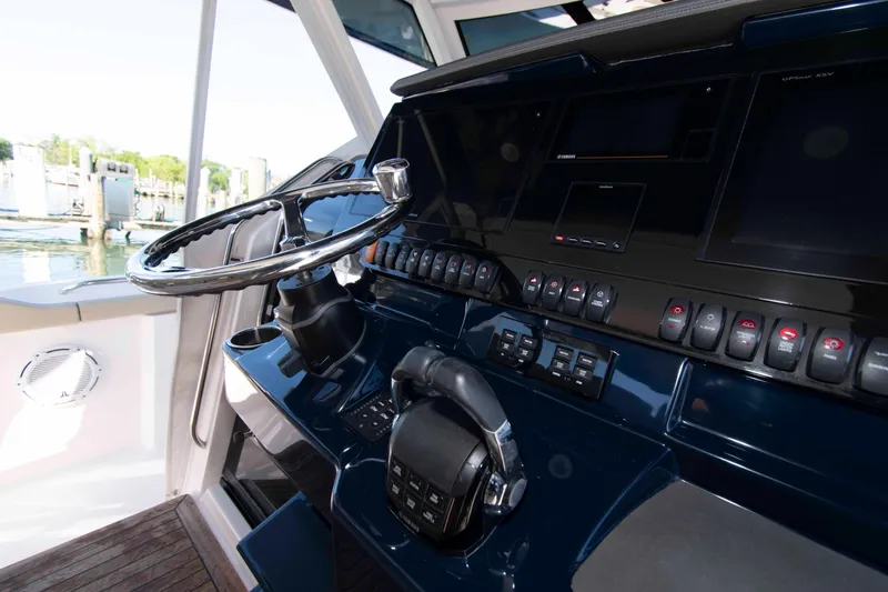 Slide: The Image of Control panel of 2019 Pursuit S 408 Sport boat with steering wheel and navigation controls. - 14