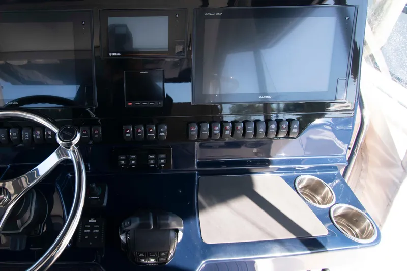 Slide: The Image of Control panel of 2019 Pursuit S 408 Sport boat with Garmin displays and steering wheel. - 15