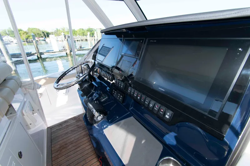 Slide: The Image of 2019 Pursuit S 408 Sport boat helm with advanced navigation displays and controls. - 16