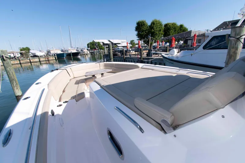 Slide: The Image of 2019 Pursuit S 408 Sport boat docked, featuring spacious seating and sleek design. - 17