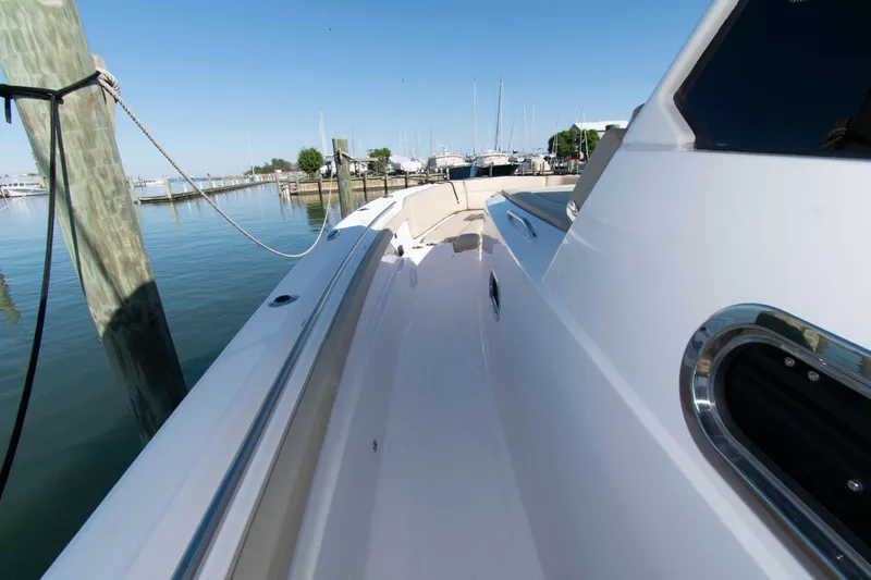 Slide: The Image of 2019 Pursuit S 408 Sport boat docked in a serene marina setting. - 20